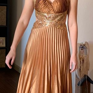 Accordion pleated copper colored prom gown